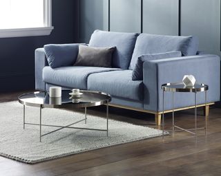 Mirrored tables in living room with blue velvet sofa by Wayfair