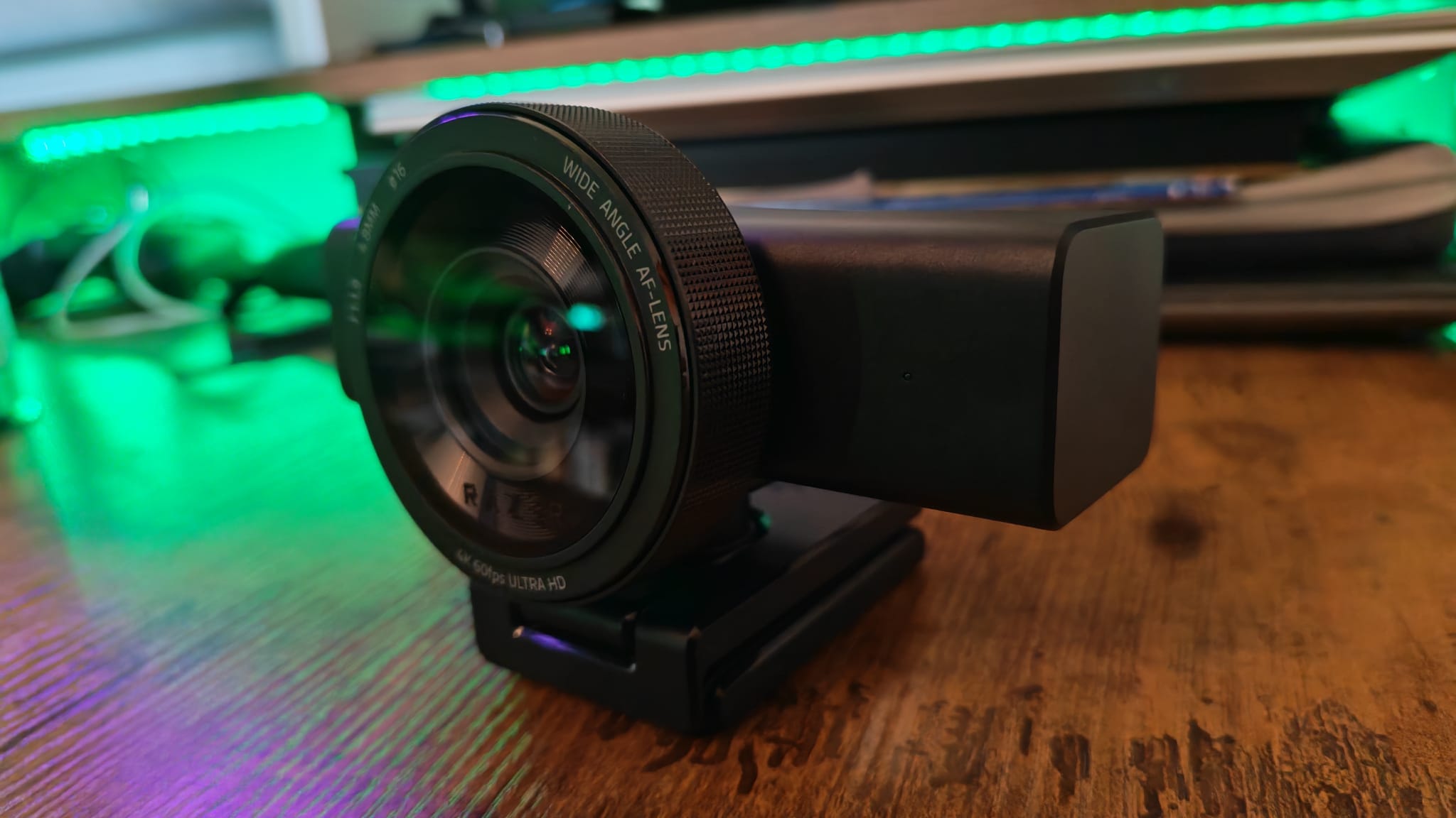 A Razer Kiyo V2 Pro webcam on a desk from a side angle