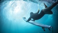 DJI Osmo Action: a woman films herself doing a barrel roll underwater while surfing
