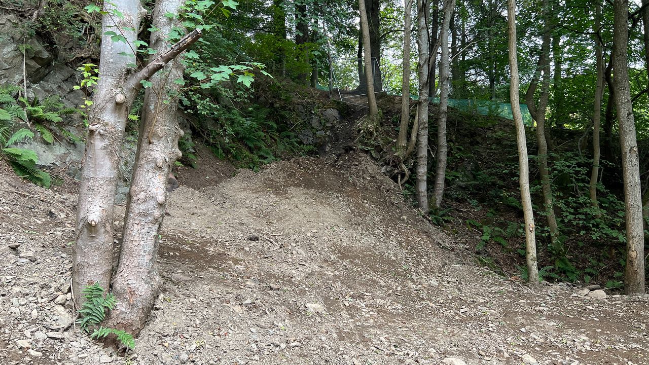 Tom Pidcock on one of the feature jumps at Glentress, Scotland
