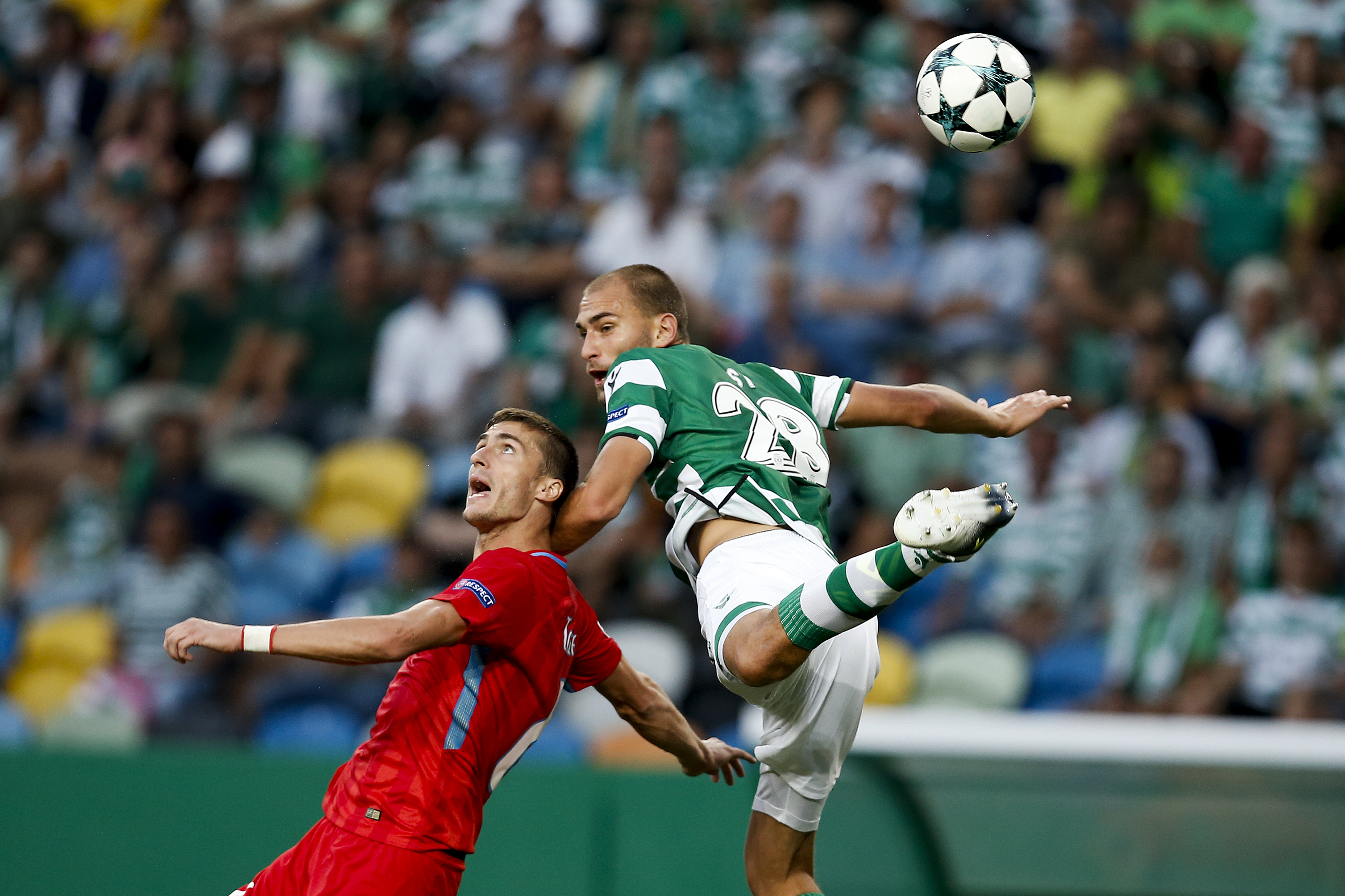 Steaua Bucharest's Ionut Darie and Sporting CP's Bas Dost compete for the ball in a Champions League qualifier in August 2017.