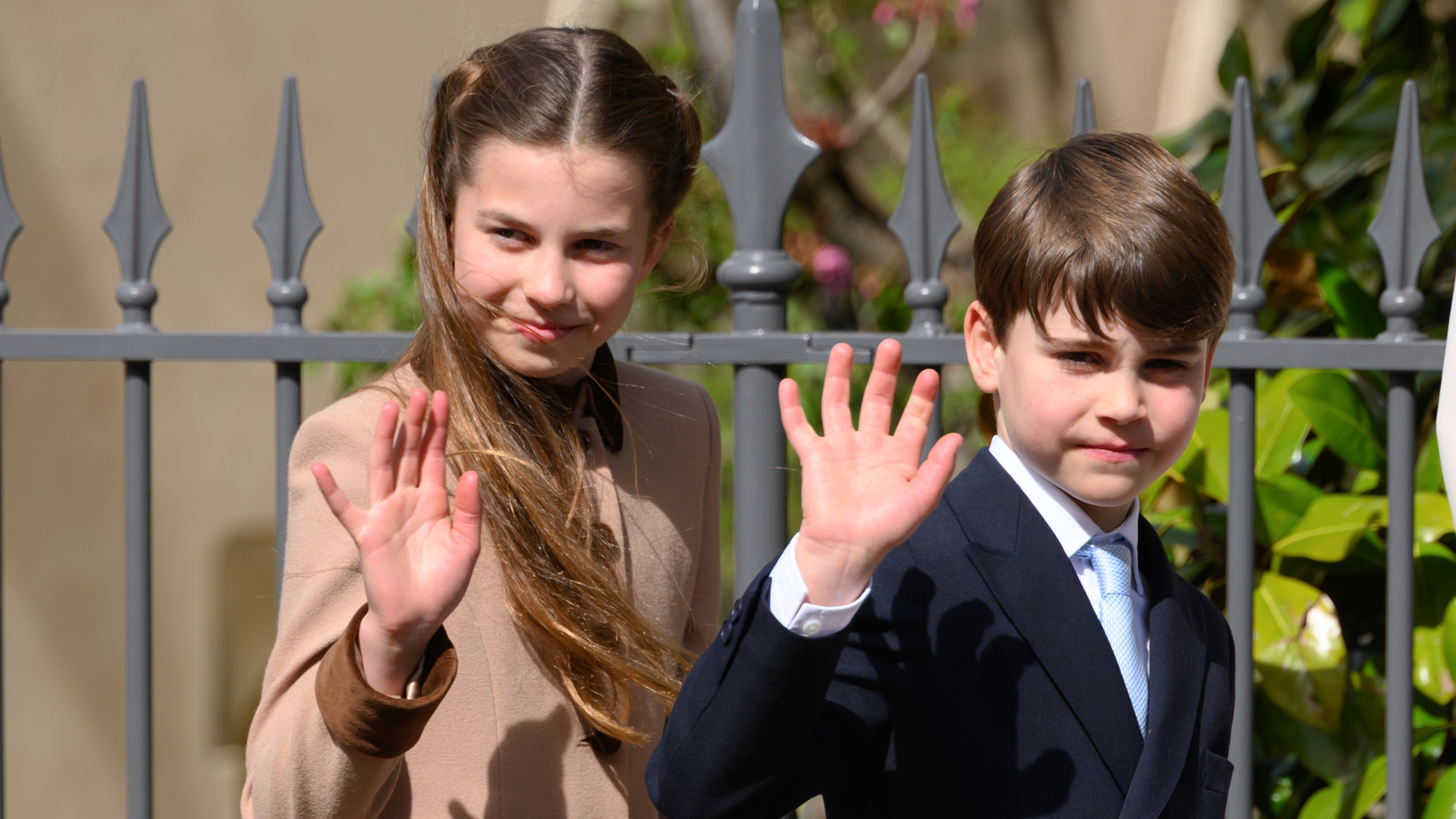 Princess Charlotte of Wales and Prince Louis of Wales wave as they depart after attending the 2026 Easter Matins Service