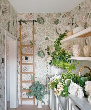 butler's pantry with patterned wallpaper, white shelving and a ladder