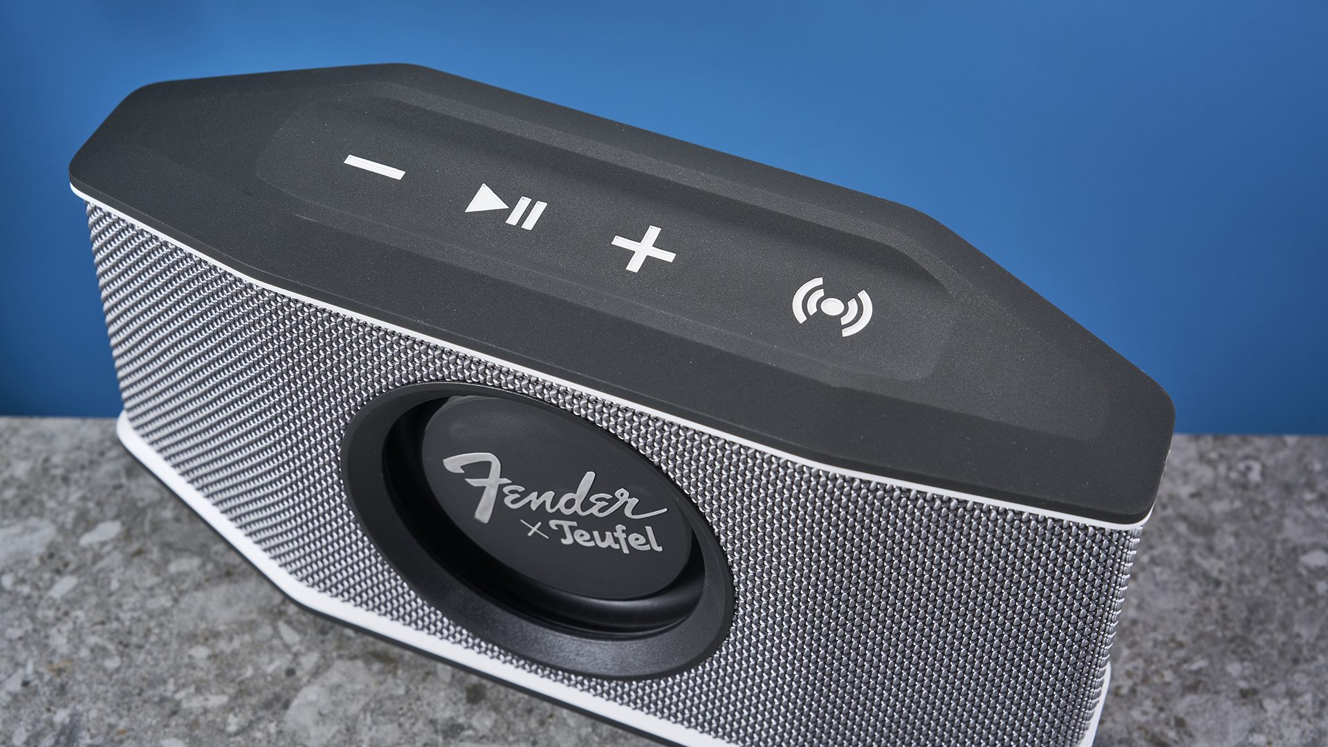 a retro-inspired bluetooth speaker 8 inches long and 4 inches tall with a circular woofer in the center branded with Fender and Teufel