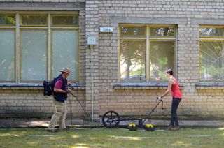 Harry Jol and Nicole Awad conduct a ground-penetrating radar survey at the site of the Great Synagogue of Vilna in Lithuania.