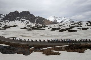 The pack rides across the San Bernardino pass Switzerland during the 20th stage of the Giro dItalia 2021 cycling race 164km between Verbania and Valle Spluga Alpe Motta Madesimo on May 29 2021 Photo by Luca Bettini AFP Photo by LUCA BETTINIAFP via Getty Images