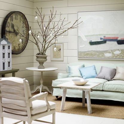 white living room with sofa set and easter tree