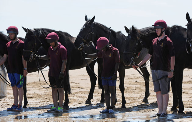 Soldiers from the Household Cavalry Regiment carry out a minutes silence for those who fell on the beach in Tunisia