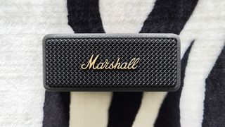 Marshall Emberton II speaker placed on a zebra-print blanket