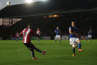 Ollie Watkins, left, scores for Exeter against Carlisle in 2017