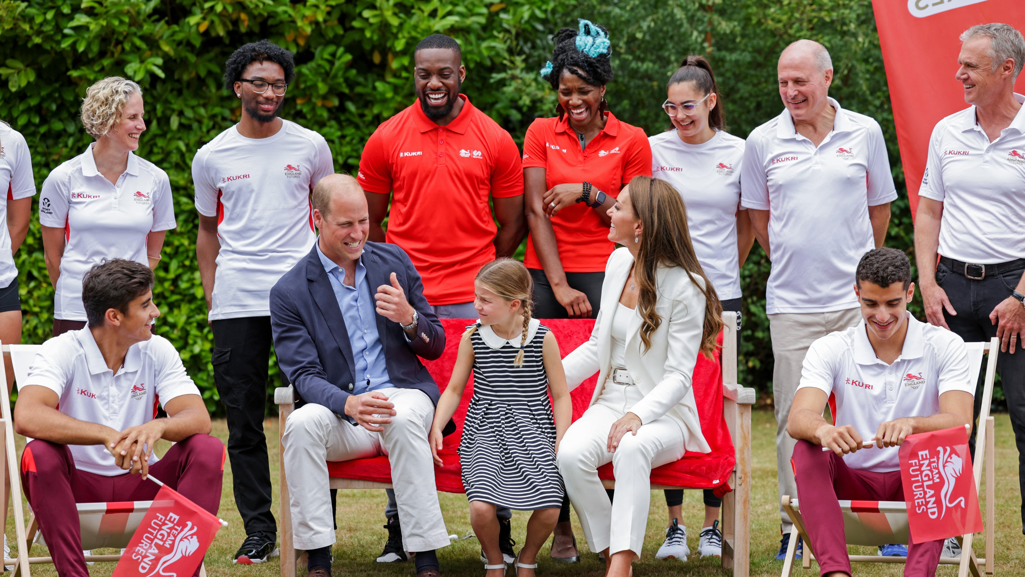 Princess Charlotte, Prince William and Catherine, Princess of Wales prepare to pose for a photograph during a visit to SportsAid House on day five of the Commonwealth Games in 2022