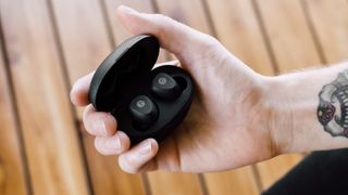 Review listing image showing Grado GT220 wireless earbuds held in hand