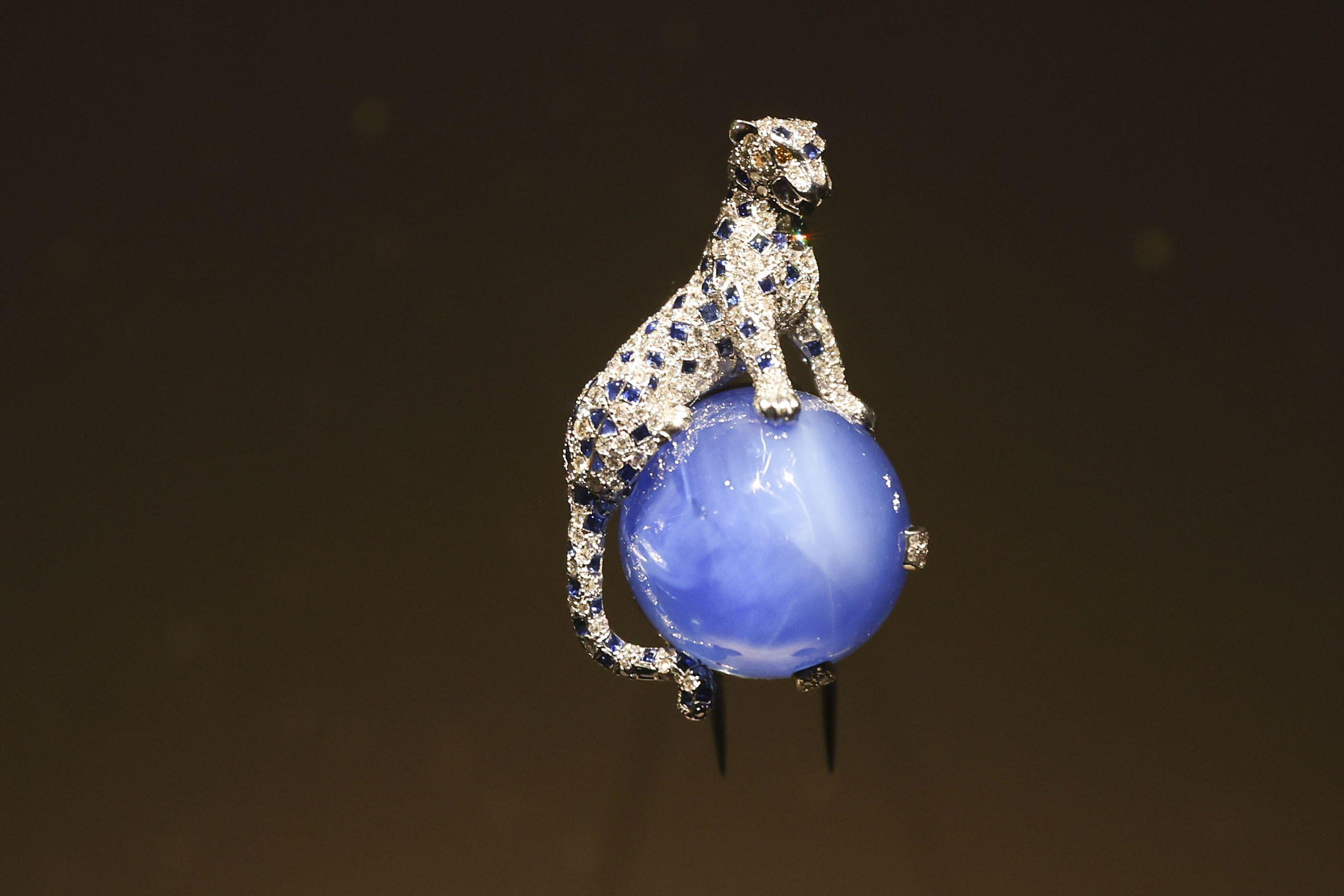 A blue stone with a diamond panther on top