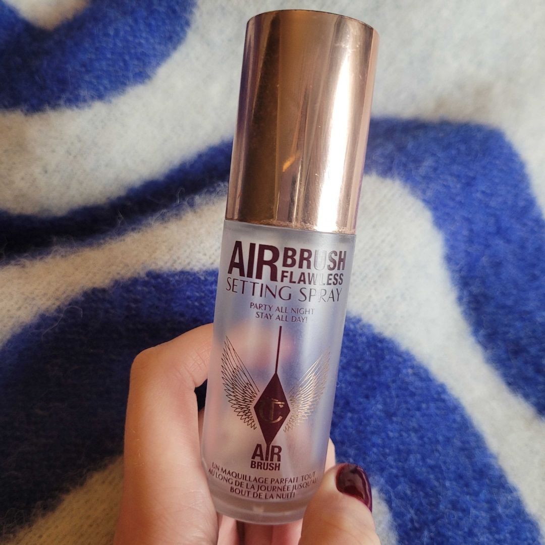 Hand holding Charlotte Tilbury Airbrush Setting Spray