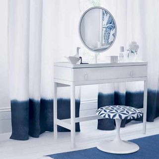 bedroom with airy dressing area with dressing table and tulip stool