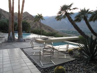 Outside view of pool and four chairs
