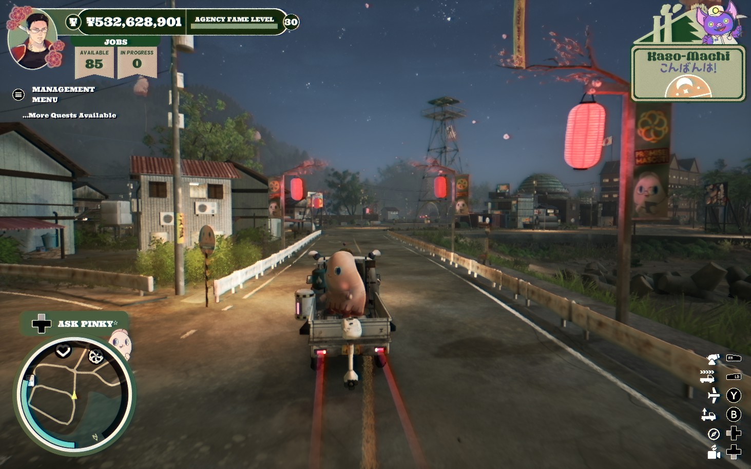 A truck drives down a dark Japanese street with a pinky finger mascot in the back
