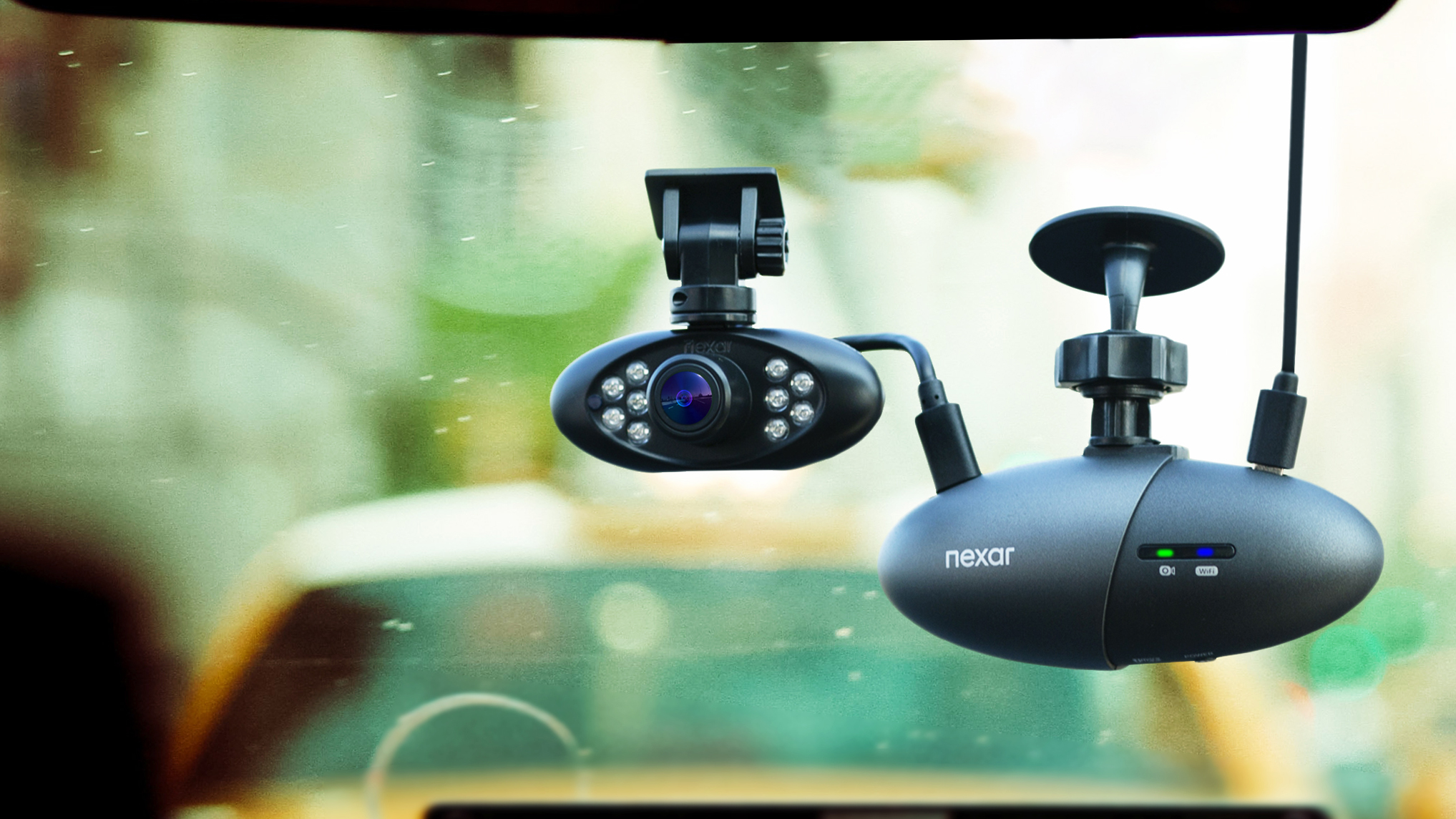 A dash cam mounted inside a car windscreen