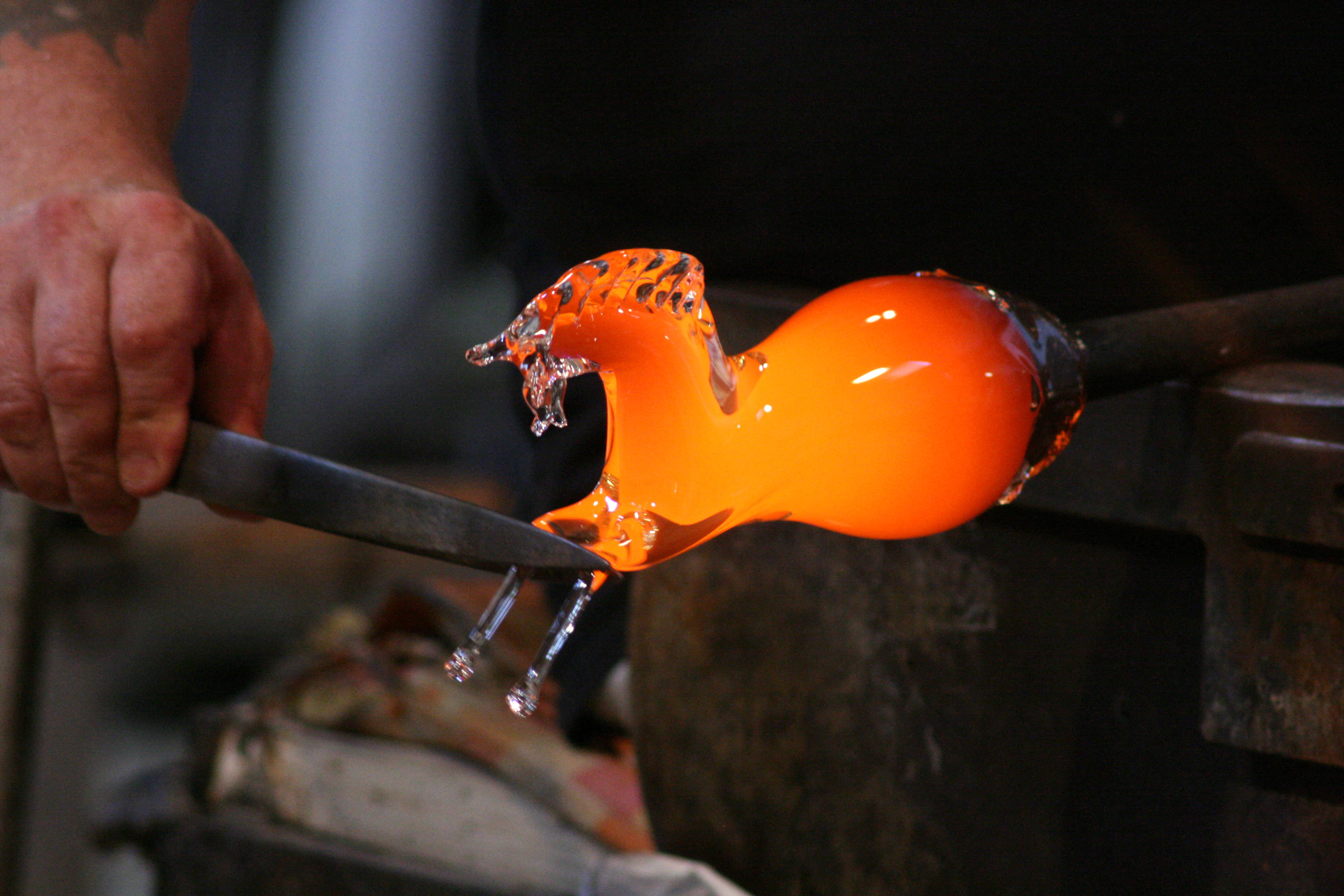 A man crafting a glass animal in a glass factory, Murano, Venice, Italy