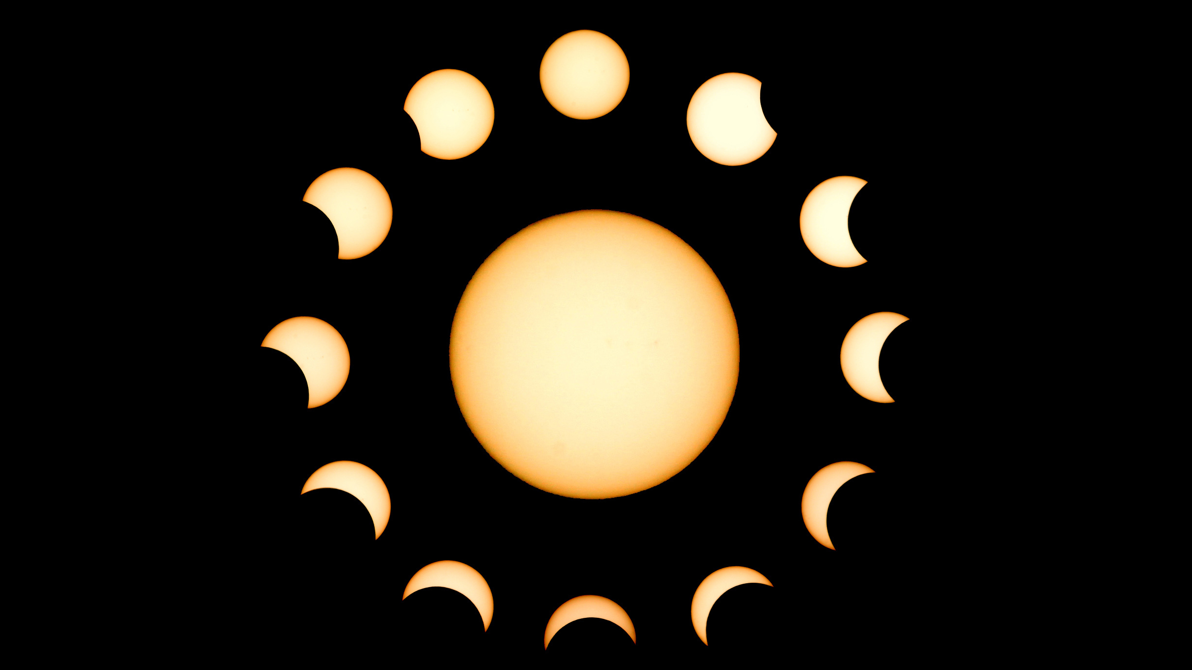 composite image of a partial solar eclipse showing the full sun in the middle surrounded by a circle of solar images during each stage of a partial solar eclipse.