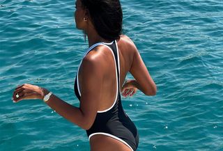 Jasmine Tookes wearing a one-piece swimsuit
