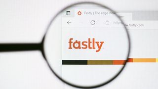 The Fastly logo as seen on its website through a magnifying glass