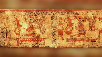 One of the two vessels discovered in the ambassador's burial shows seated figures wearing headdresses performing a fire ritual.