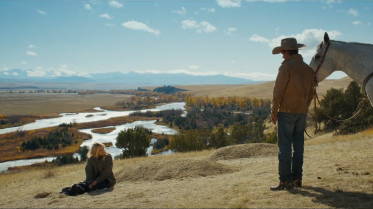 Stacy sitting on the ground next to two graves as Cade walks up to her with his horse.