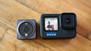GoPro HERO 10 Black and DJI Action 2 next to each other on a table