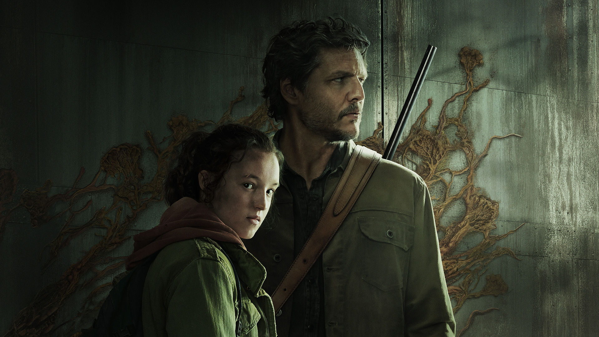 Bella Ramsey's Ellie and Pedro Pascal's Joel look in different directions in a promotional image for The Last of Us