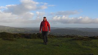 Hiker wearing a Peak Performance Helium Utility Flo Jacket in Dartmoor