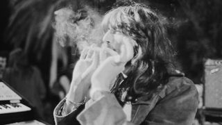 Keyboard player Jon Lord (1941-2012) smoking two cigarettes simultaneously on stage at the Ontario Motor Speedway, Ontario, California, where he performed with English rock group Deep Purple at the California Jam rock festival, 6th April 1974.