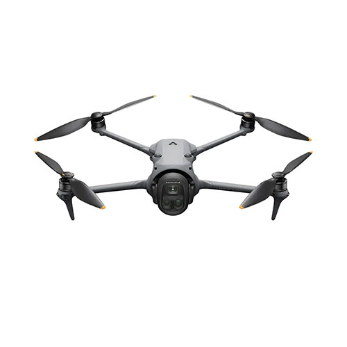 A grey drone with four propellers attached at each corner of the body has a black camera on the front and is on a white background.