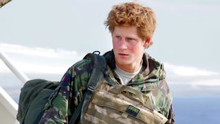 Prince Harry, carrying his rucksack and wearing a flak jacket, disembarks an RAF Lockheed TriStar transport aircraft