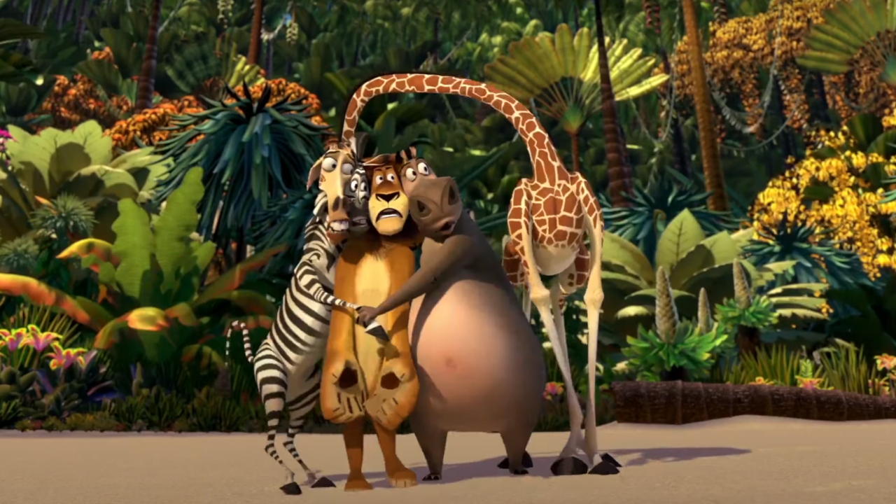 The main animal cast of Madagascar huddle together on a beach in fright.