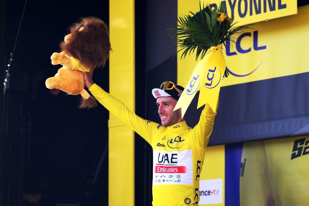 BAYONNE FRANCE JULY 03 Adam Yates of United Kingdom and UAE Team Emirates celebrates at podium as Yellow leader jersey winner during the stage three of the 110th Tour de France 2023 a 1935km stage from AmorebietaEtxano to Bayonne UCIWT on July 03 2023 in Bayonne France Photo by David RamosGetty Images