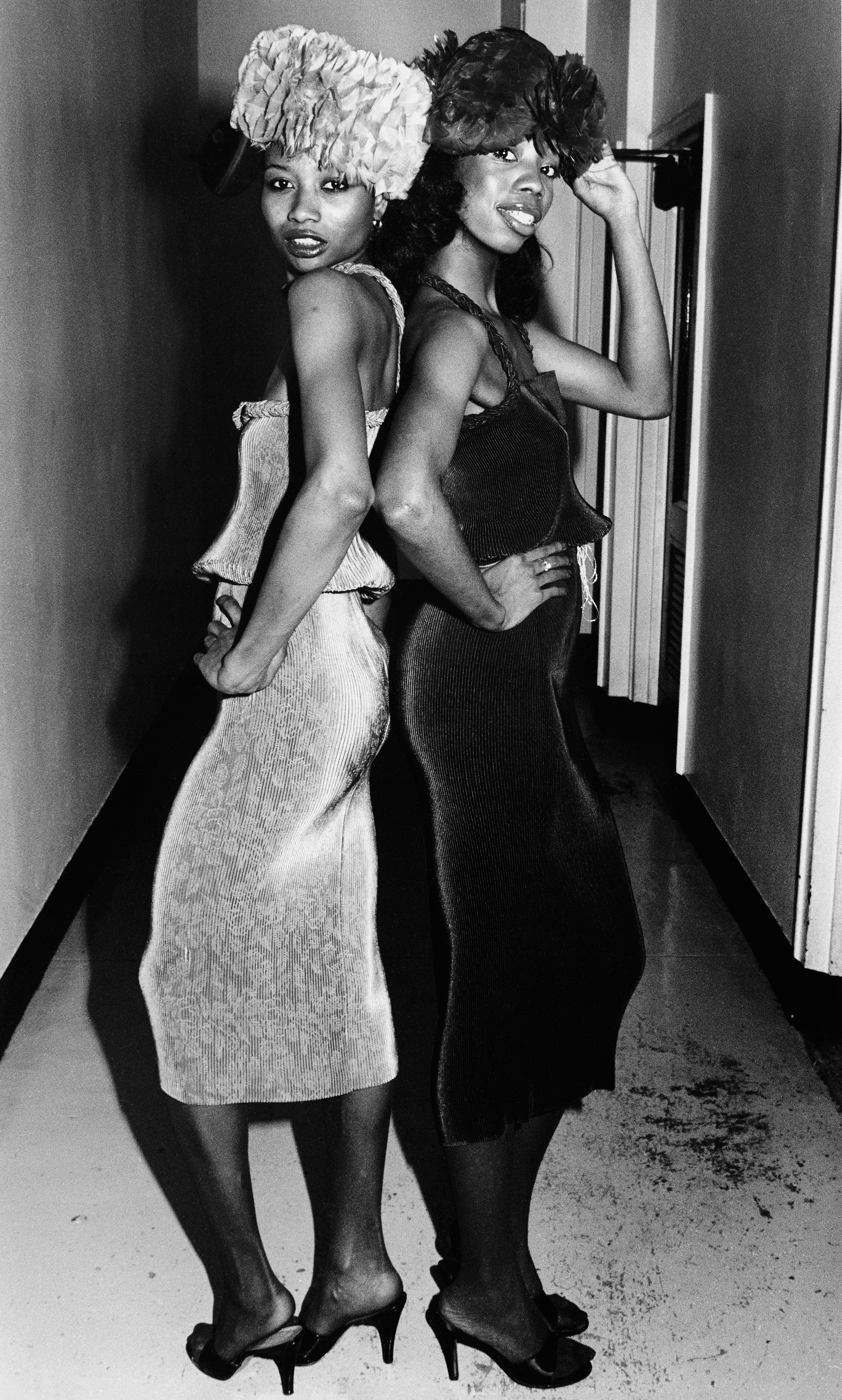 Coreen Simpson black and white portrait of two women dressed up, back to back