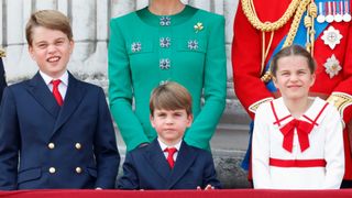 Prince George, Prince Louis, Catherine, Princess of Wales, Princess Charlotte and Prince William, Prince of Wales watch an RAF flypast from the balcony of Buckingham Palace