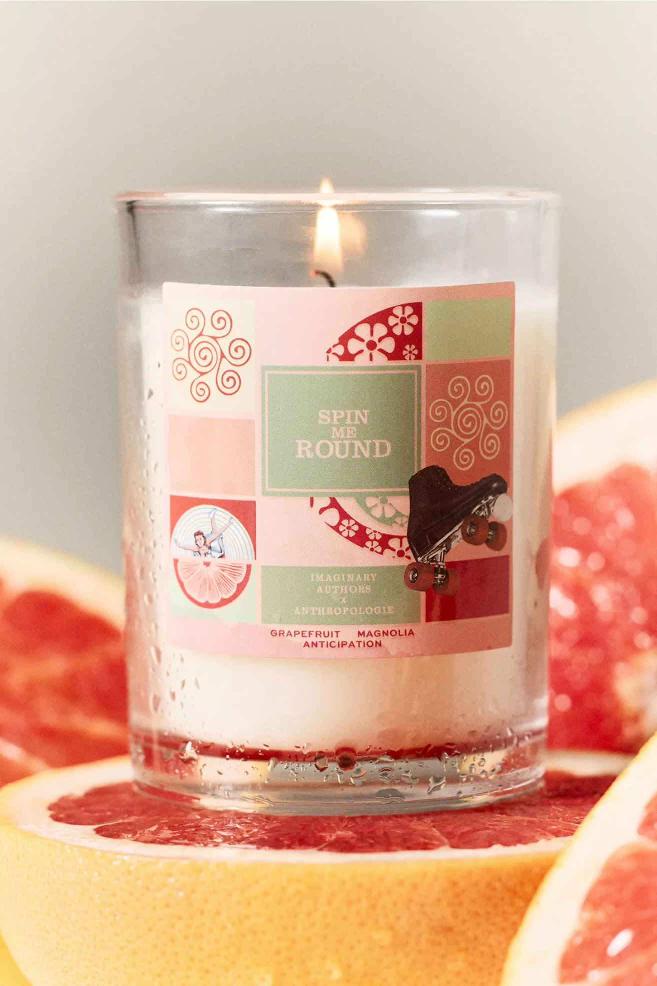 A glass candle on a grapefruit half