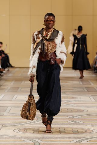 Zimmermann model wears shearling coat