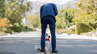 Man speaking to dog on a walk