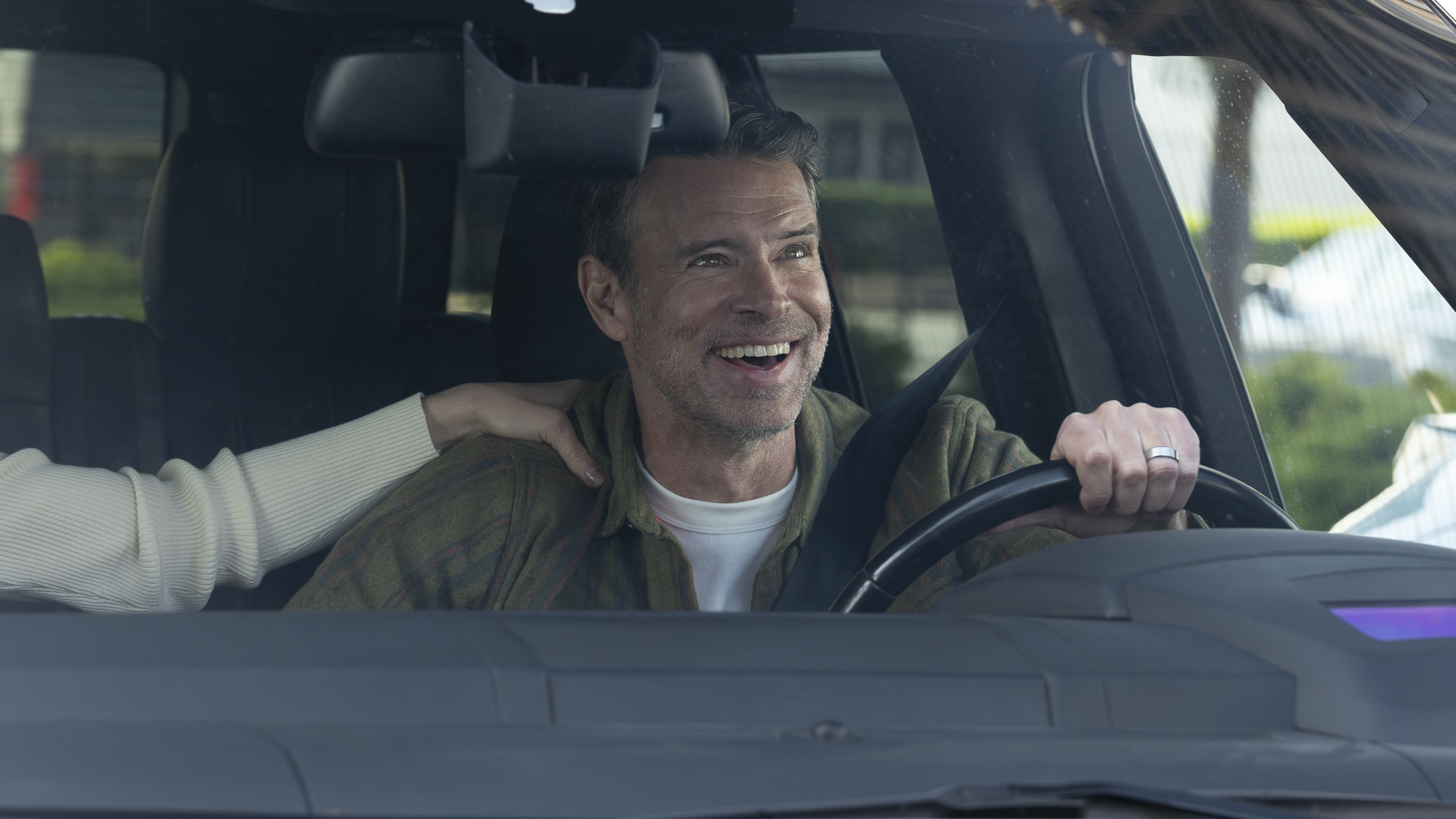 Dr. Seth McDale (Scott Foley) is happy while driving in Will Trent.