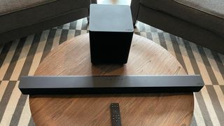 The Vizio V-Series 2.1 Home Theater Soundbar V21-H8 placed on a wooden table