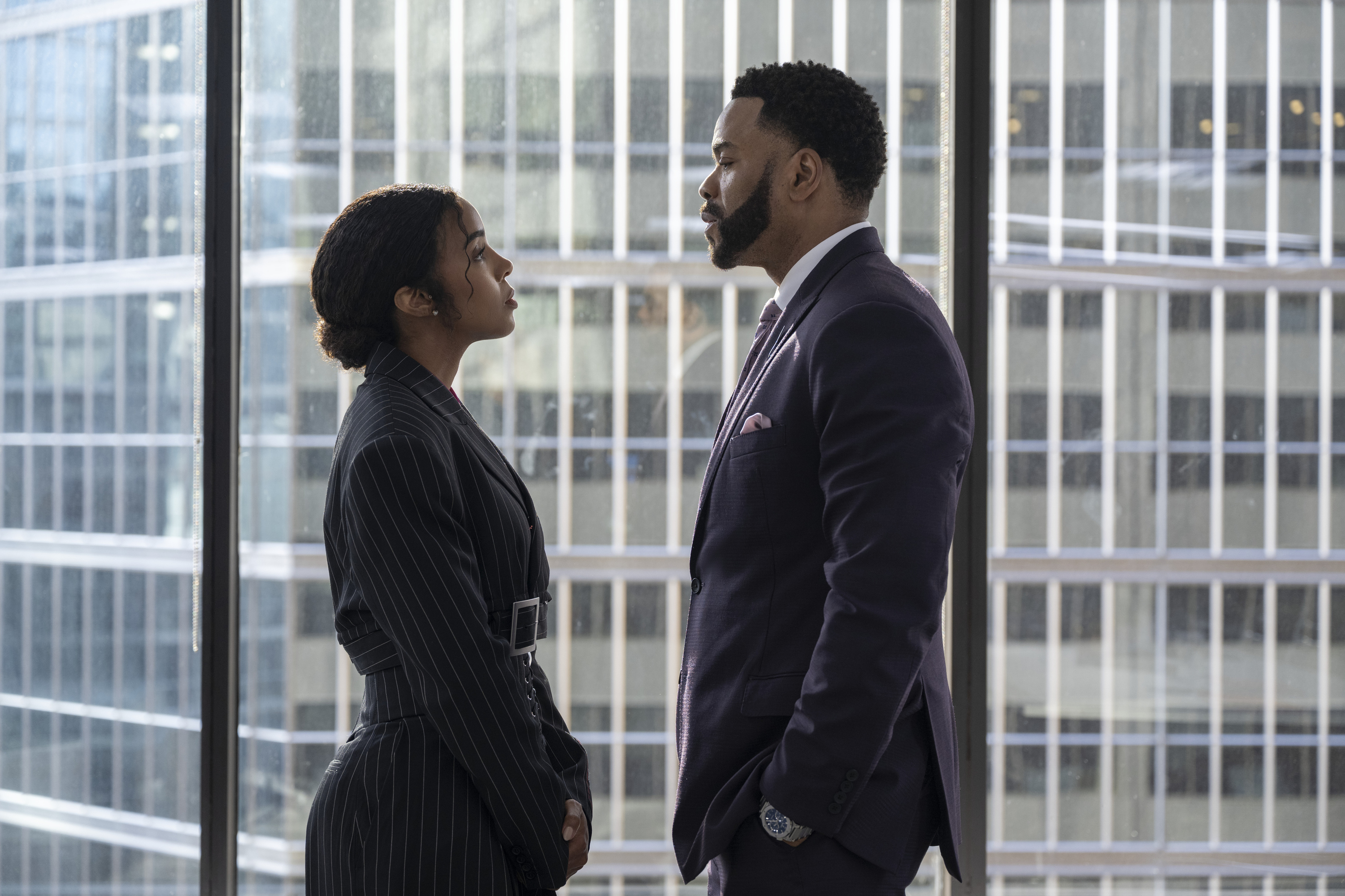 kelly rowland and method man stare into each other's eyes while wearing professional dress in a high rise office in a still from the movie relationship goals