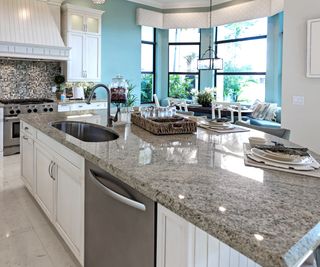 Beautiful modern kitchen with natural gray stone counter height bar