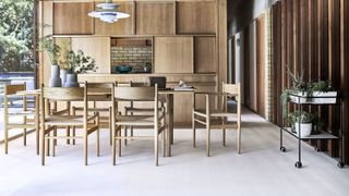 open plan wooden kitchen diner with pale laminate floor