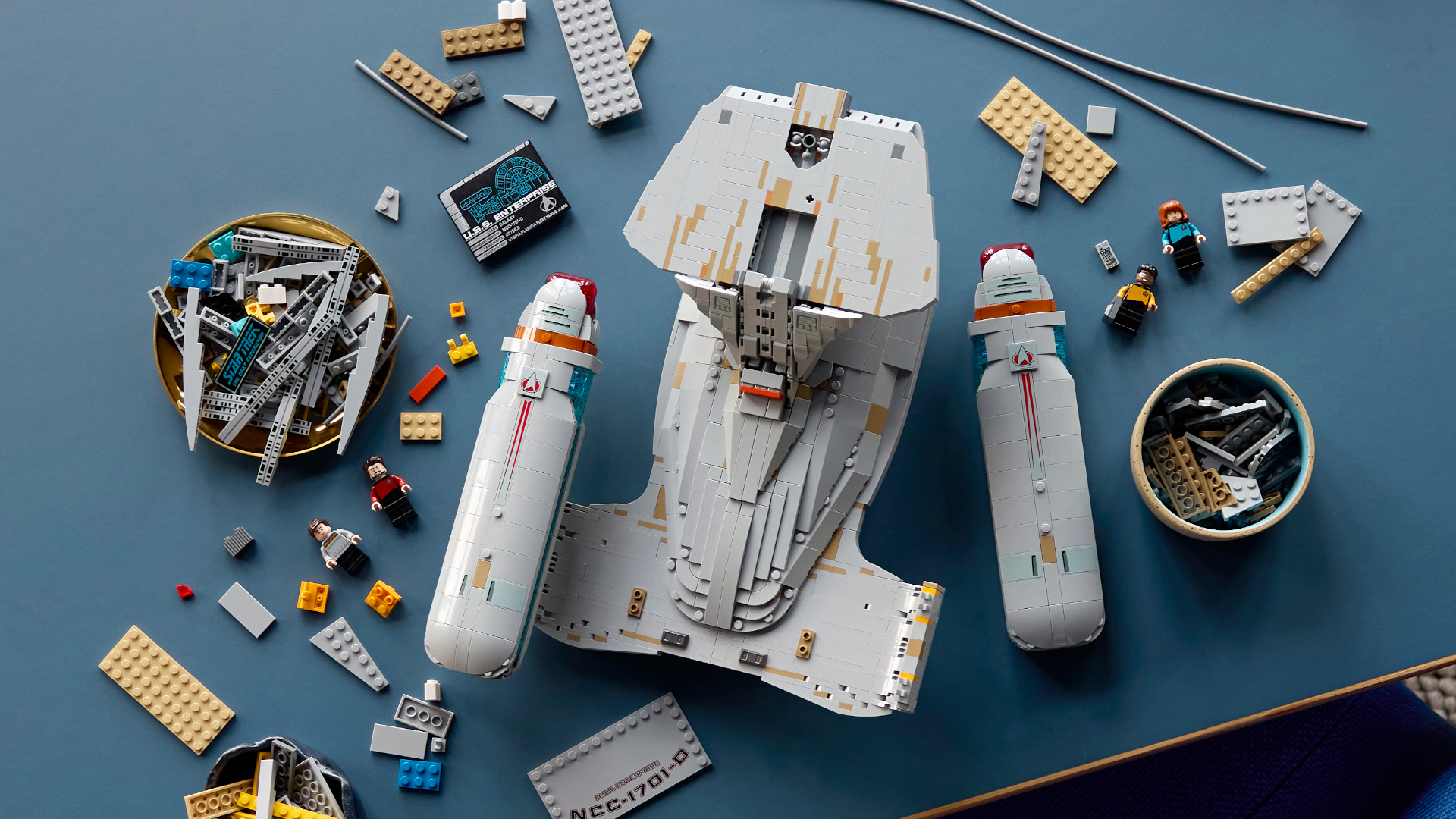 The Lego Enterprise set, mid-construction on a blue table