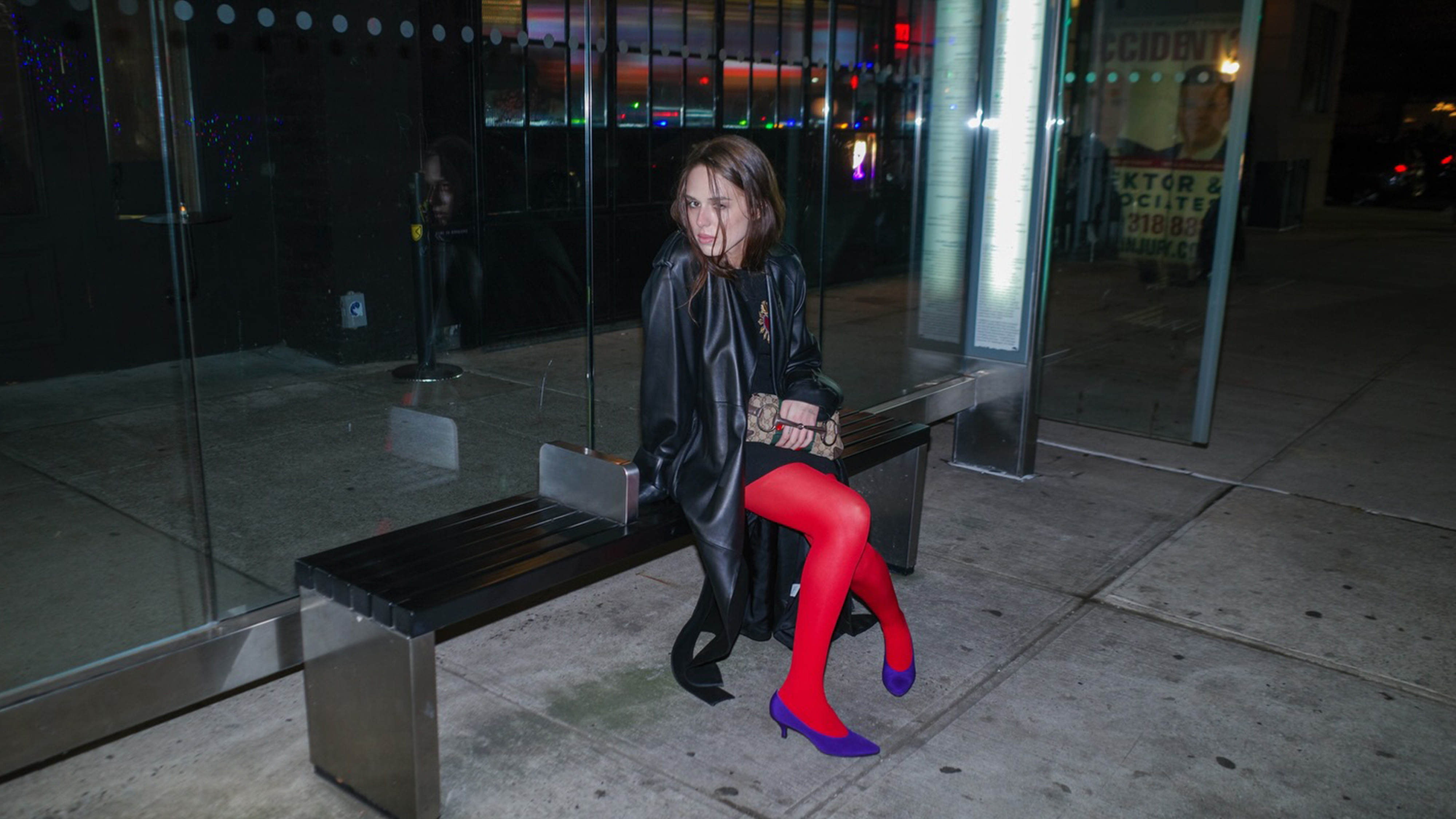Lucy Rae Mcfadin wearing a black outfit with red tights and purple kitten heels.