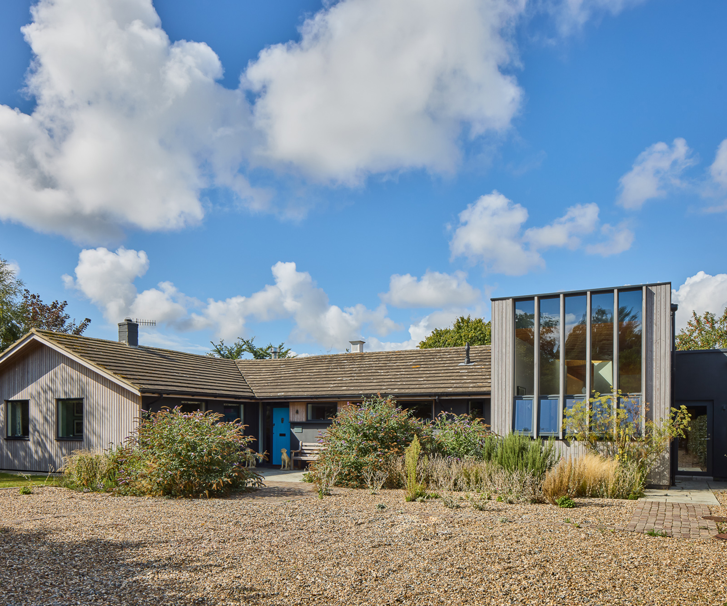 Exterior of a newly renovated home with gravel driveway
