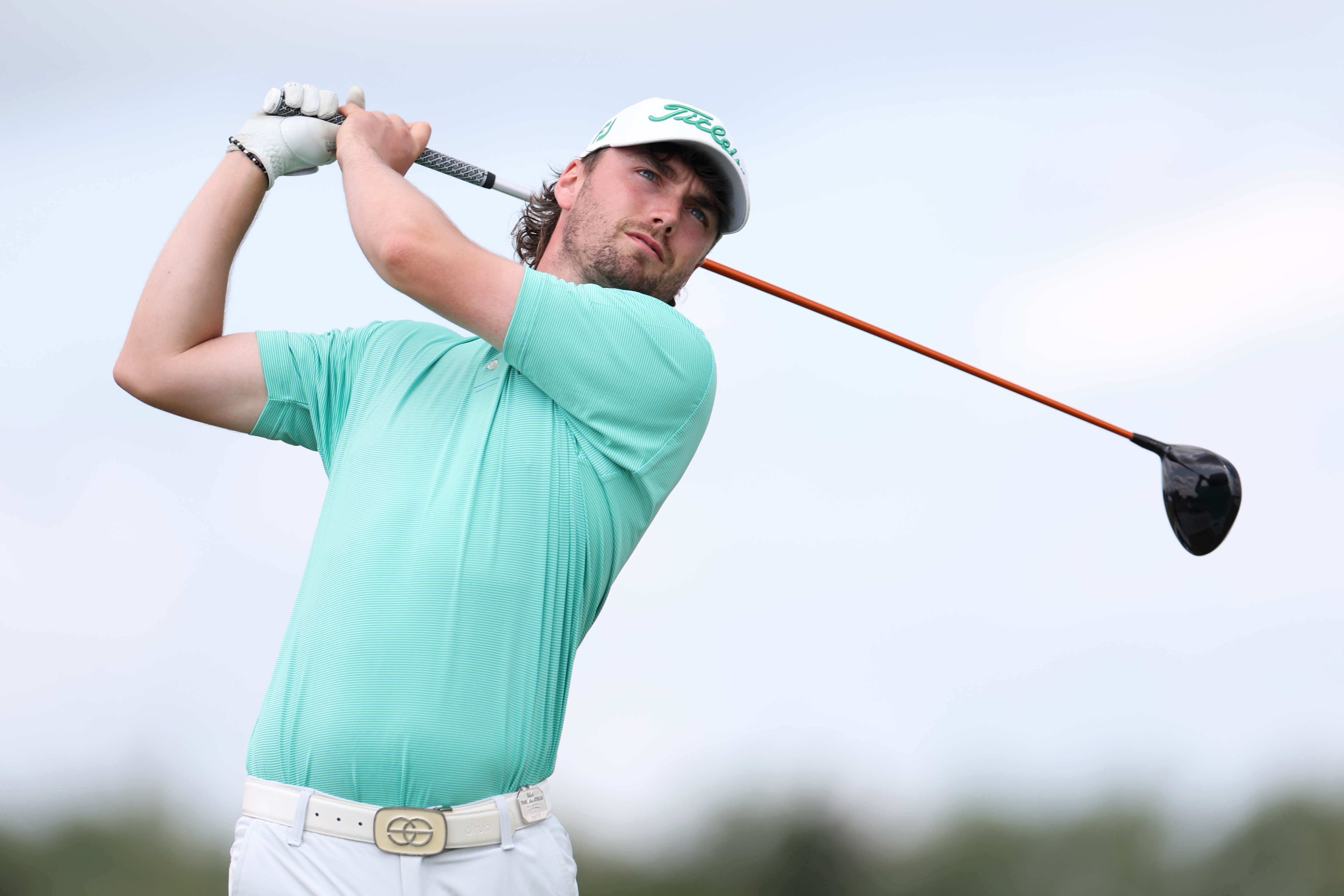 Cameron Adam hits a drive during practice before The Amateur Championship in 2025